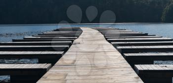 Wooden pathway between empty boat docks after boats are removed for the winter on Cheat Lake