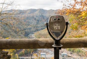 Close up of disabled wheelchair accessible coin operated binoculars or telescope at Hawks Nest State Park in fall colors