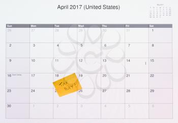 Electronic calendar on computer monitor showing the due date and filing deadline for income tax forms in the USA for 2017