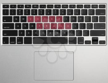 Laptop or PC computer keyboard with letter spelling Voter Fraud highlighted in red illustrating potential vote errors with illegal votes and need for recount