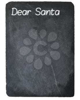 Dear Santa text message written in chalk on a chalky natural slate blackboard isolated against white background with copy space