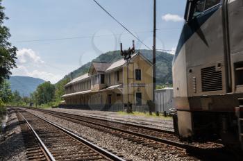 Amtrak train passes old station building in ghost town of Thurmond West Virginia are owned by the National Park Service