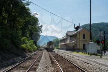 Amtrak train passes old station building in ghost town of Thurmond West Virginia are owned by the National Park Service