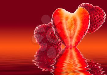 Freshly sliced strawberry in shape of heart with two others in background reflected in pure water against red orange background