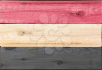 Timber planks of wood that have been painted or stained in the colors of a flag of Yemen as a background