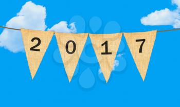 High resolution isolated sack cloth pennants with the letters embossed on each to create pennant flag message of 2017 in the sky for New Year message