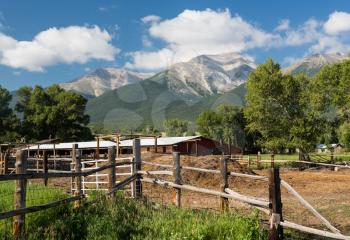 Farmyard and stables behind fencing with Mount Princeton near Buena Vista Colorado