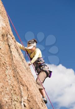Senior female climber on rope assisted climb on Turtle Rocks near Buena Vista Colorado