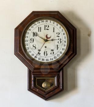 Ornate and complex clockwork wall clock with date indication in Interior of Meeks Store in the national park at Appomattox Virginia