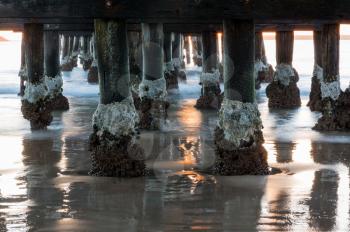 Sun rise illuminates structure of pier at Coffs Harbour in New South Wales Australia