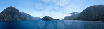 Panorama of channel in Doubtful Sound on South Island of New Zealand aboard a cruise ship showing strong headwinds coming towards the ship