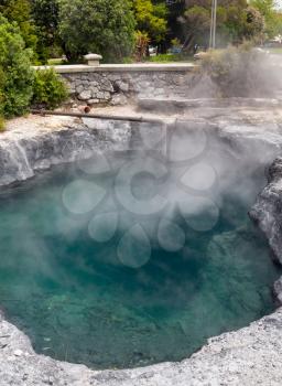 Blue steaming water of Rachel Spring in Government Park in Rotorua on the North Island of New Zealand