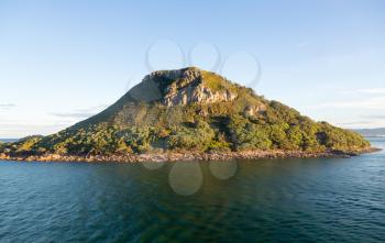 Leaving Tauranga Harbour with view of the side of The Mount in New Zealand