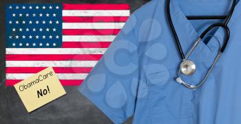 Blue doctor scrubs shirt and stethoscope hang empty in front of USA flag. Illustration of healthcare system problems with question about ObamaCare replacement