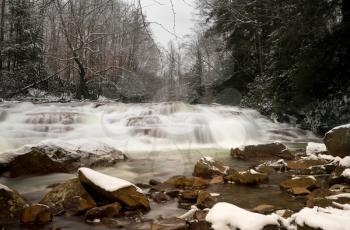 Winter snow shot of waterfall with blurred motion on Muddy Creek running into Cheat River off Route 26 in Preston County West Virginia