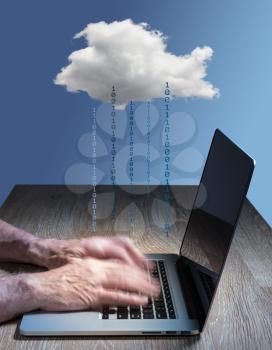 Laptop connected to applications in the cloud computing internet with furious typing suggestive of hacking