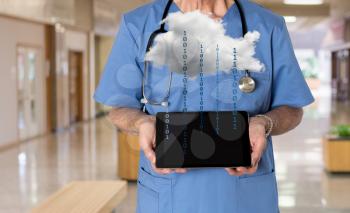 Senior male caucasian doctor with stethoscope in medical scrubs holding electronic tablet. Connection to electronic medical records via WiFi to cloud computing applications