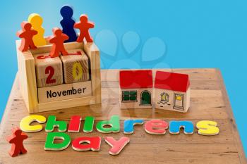 Childs wooden blocks and magnetic letters spell out Children's Day for 20 November
