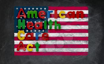 Childs magnetic letters spell American Health Care Act in congress. This is superimposed on a US flag chalked onto a blackboard