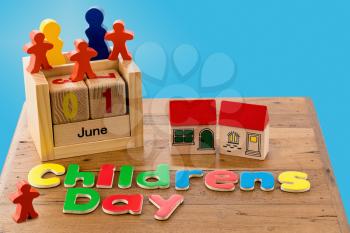 Childs wooden blocks and magnetic letters spell out Children's Day for June first