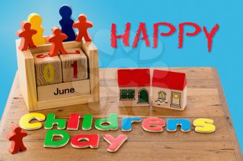 Childs wooden blocks and magnetic letters spell out Children's Day for June first