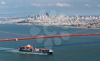 SAN FRANCISCO - APRIL 19: MOL container ship enters San Francisco Bay under Golden Gate Bridge on April 19, 2017. The MOL Guardian is 275m long.