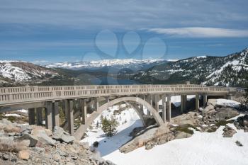 Donner bridge above Truckee lake in snow covered Sierra Nevada mountains from Donner Pass in April