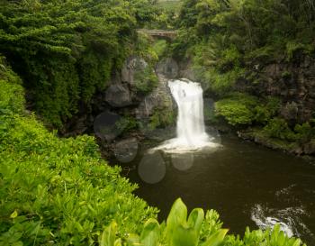 Road to Hana continues over bridge over waterfall into Seven Sacred Pools at state park