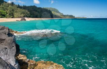 Rocks frame the turquoise ocean off Lumahai Beach in Kauai in Hawaiian islands
