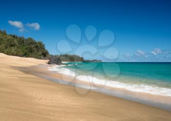 Golden sands with warm turquoise ocean off Lumahai Beach in Kauai in Hawaiian islands