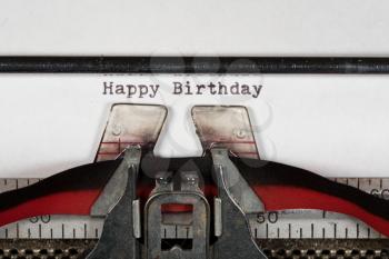 Macro detail of the ink ribbon and text of Happy Birthday on electric typewriter for greeting card message