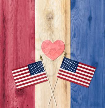 Painted timber planks of wood in the colors of a flag for USA with small flags for fourth of July celebration