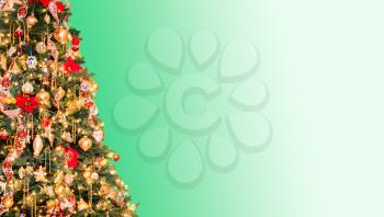 Ornately decorated christmas tree with light green background for copy space for holiday message