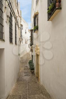 Narrow street in old town of Arcos de la Frontera near Cadiz in Spain