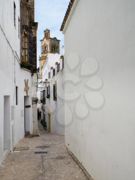 Narrow street in old town of Arcos de la Frontera near Cadiz in Spain