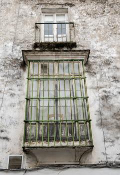 Window in dirty mold covered house in Arcos de la Frontera near Cadiz in Spain