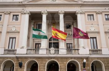 Spanish, Cadiz and Andalucia flags fly outside the town hall of the city of Cadiz in Southern Spain