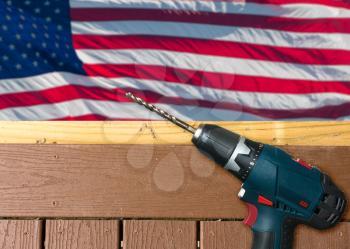 Drill on composite deck in front of USA flag for Labor Day background poster