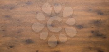 Aerial or above shot of a dark wooden table top with timber and knots