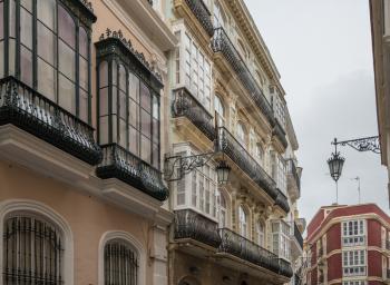 Cast iron balconies on Calla Ancha shopping street in city of Cadiz in Southern Spain