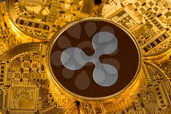 Illustration of ripple coin on gold background to illustrate blockchain and cyber currency