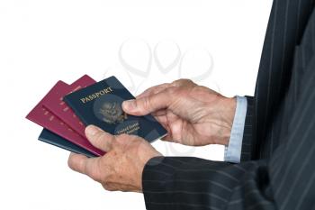 Isolated image of a senior man arm in suit choosing which passport to use