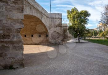 Dry riverbed under stone bridge in old city of Valencia on coast of Spain