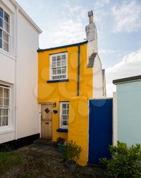 Old stone plaster and painted homes in narrow street in Appledore, Devon