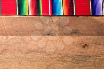 Cinco de Mayo background image on with serape cloth blanket on wooden rustic boards