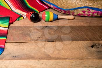 Cinco de Mayo background image on with maracas and sombrero on wooden rustic boards