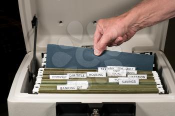 Close up of a well organized home filing system with tabs for each subject in fireproof safe
