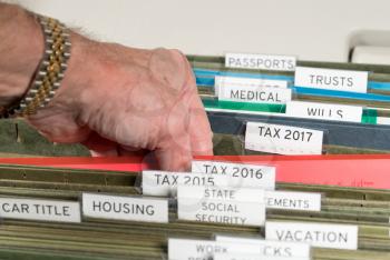 Close up of a well organized home filing system with tabs for each subject and focus on tax return papers for 2017