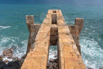 View down the old concrete pineapple dump pier by bicycle path in Kapa'a