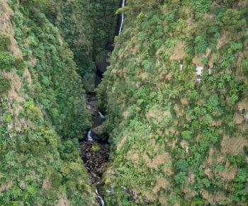 Aerial view of Hanakoa Falls on hawaiian island of Kauai from helicopter flight